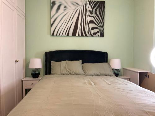 a bedroom with a bed with a picture of a zebra at MAYE HOUSE 