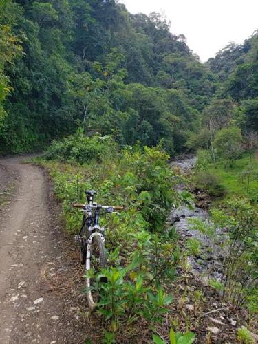 a bike parked on the side of a dirt road at Studio House in Eco-Farm: nature, relaxing, hiking in Turrialba