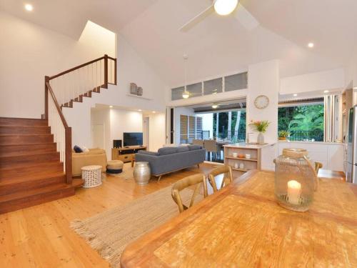 a living room with a dining table and a living room at Beach Villa - a Short Walk to Town & Beach in Port Douglas