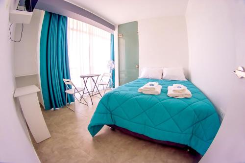a bedroom with a bed and a table with chairs at LAS GAVIOTAS DE PARACAS in Paracas