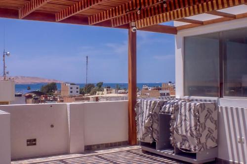 a balcony with a view of the city and the ocean at LAS GAVIOTAS DE PARACAS in Paracas