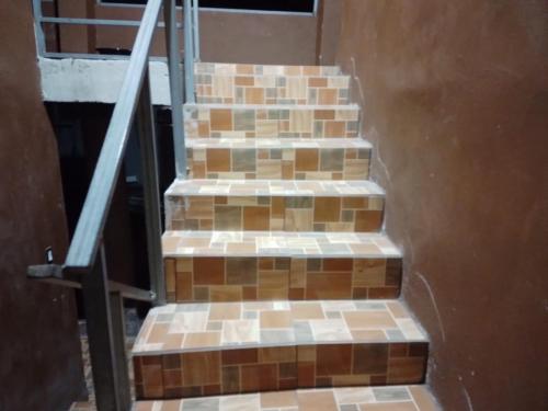 a set of stairs with brown and white tiles at Apartamentos HJJ N 2 in Puerto Limón