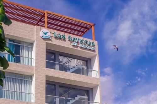a building with a sign on the side of it with a bird at LAS GAVIOTAS DE PARACAS in Paracas