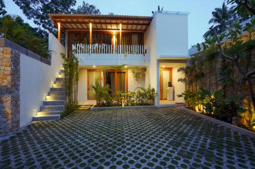 uma casa com uma escada que leva até ela em Karyana Apartment em Kuta Lombok