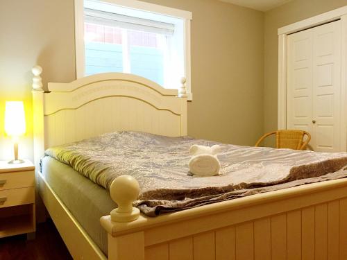 a teddy bear sitting on top of a bed at JESI'S NEW HOUSE, Self Enter 2BR, Whole Suite, Close to White Rock Beach & US Border in Surrey