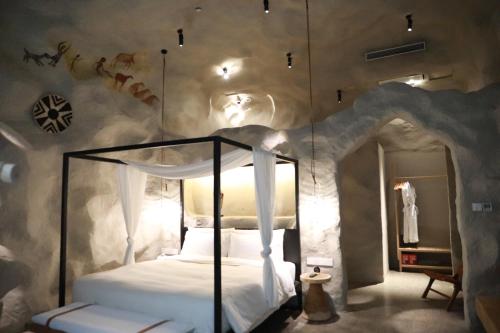 a bedroom with a bed in a rock wall at Shanghai Pudong Airport Moonlo Hotel - Pet Friendly in Shanghai