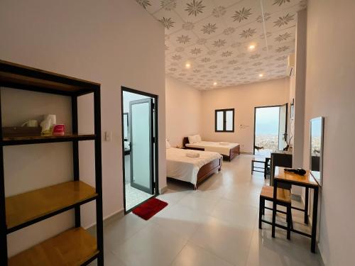 a bedroom with a bed and a living room at Huong Giang Bungalow in Phú Quốc