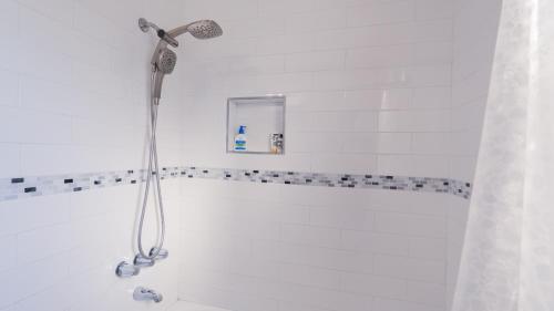 a shower with a shower head in a bathroom at Long Beach Cozy Remodled Home in Long Beach