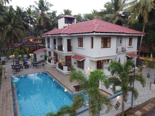 an aerial view of a house with a swimming pool at Coastal Suites Apart Hotel ---- 8 minutes walk to beach in Benaulim
