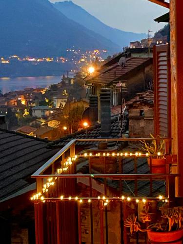 a building with christmas lights on top of it at Romantic home stone with amazing view lake of Como and Oleandra in Laglio