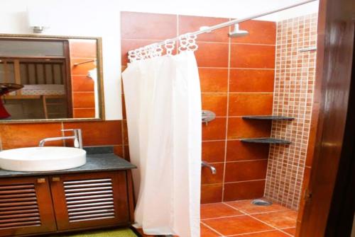 a bathroom with a shower with a white shower curtain at Jugglers Rest 4 Sharing in Bangalore