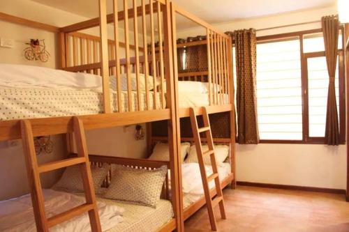 a room with two bunk beds and a window at Jugglers Rest 4 Sharing in Bangalore