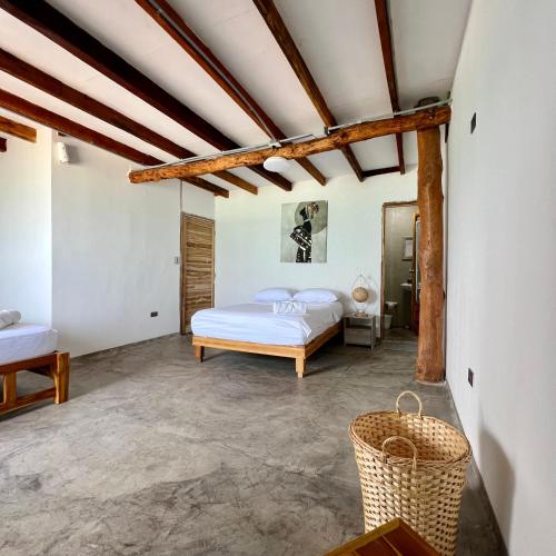 a bedroom with a bed and a basket at Cabañas W Beach in Cartagena de Indias