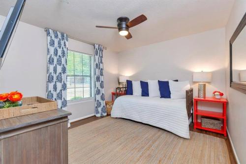 a bedroom with a bed with blue and white pillows at Grapevine Oasis, with Pool in Grapevine