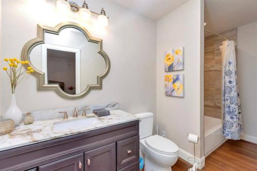 a bathroom with a sink and a mirror at Grapevine Oasis, with Pool in Grapevine