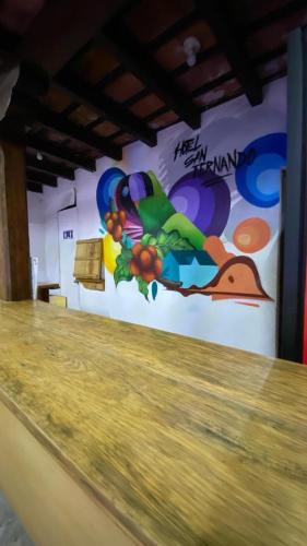 a wall with a mural of a bird on it at Hotel y Restaurante San Fernando. in Jocotenango