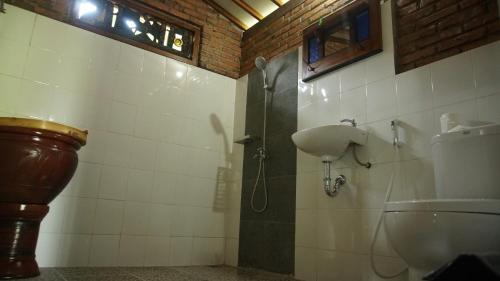 a bathroom with a shower and a toilet at Omah Dekso 