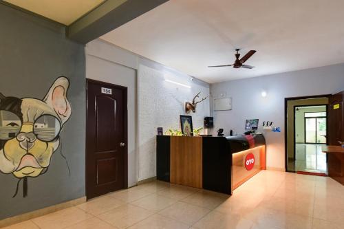 a lobby with a counter with a painting of a dog at Urban Legends in Bārang