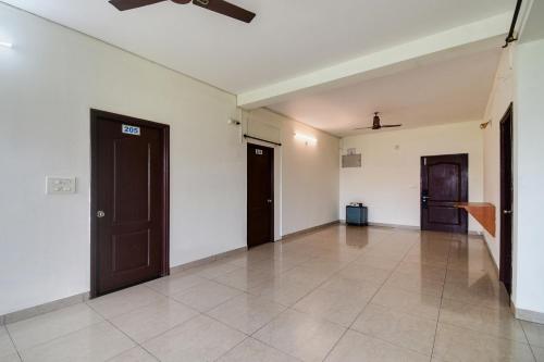 an empty room with two doors and a tile floor at Urban Legends in Bārang