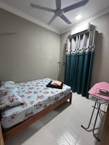 ein Schlafzimmer mit einem Bett und einem grünen Duschvorhang in der Unterkunft WAJA HOMESTAY in Kampong Pengkalan Nyireh