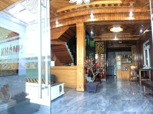 a shop with a wooden ceiling and a glass door at KHÁNH AN HOTEL in Da Lat