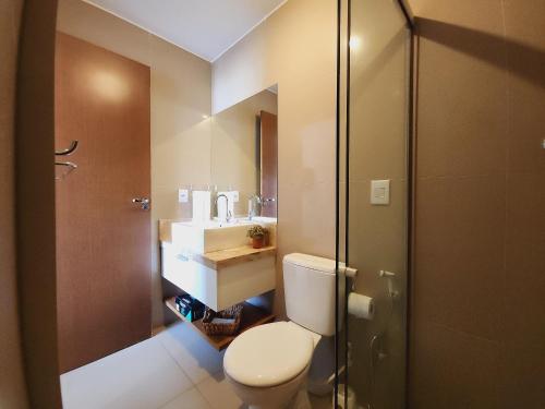 a bathroom with a toilet and a sink and a shower at JPN18 - Duplex em condomínio fechado próx. à praia in Natal