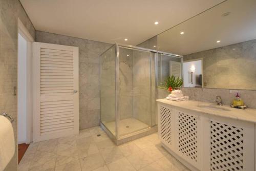 a bathroom with a shower and a sink and a showerspective at The Condo - A Spacious Villa Near Beach and Town in Port Douglas