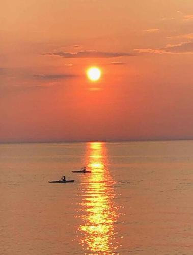 two people in a boat on the water at sunset at Bluewater Delight in Sarnia