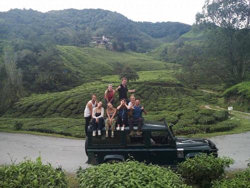 a group of people standing on the back of a truck at A3A Oastel CoLiving in Tanah Rata