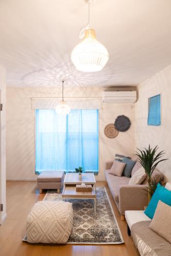 a living room with a couch and a table at USJ 大阪梅田駅へ15分の広々3LDK戸建 at 野田 in Osaka