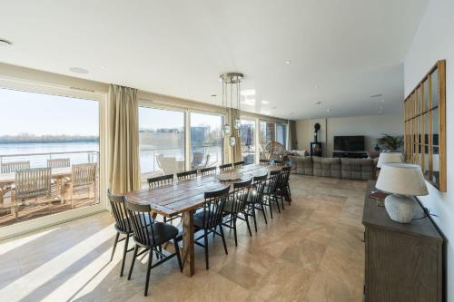 a dining room with a table and chairs and a large window at 10 Bowmoor Edge By Birch Stays 