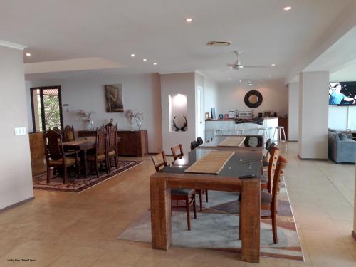 a dining room and living room with a table and chairs at Yachtsmans Paradise, Whitsundays in Airlie Beach