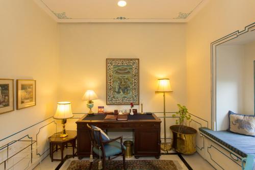 an office with a desk and a chair in a room at Shiv Niwas Palace by HRH Group of Hotels in Udaipur