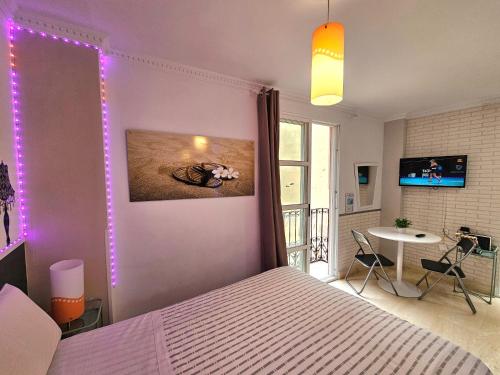 a bedroom with a bed with purple lights on the wall at Loft Pasarela in Alicante