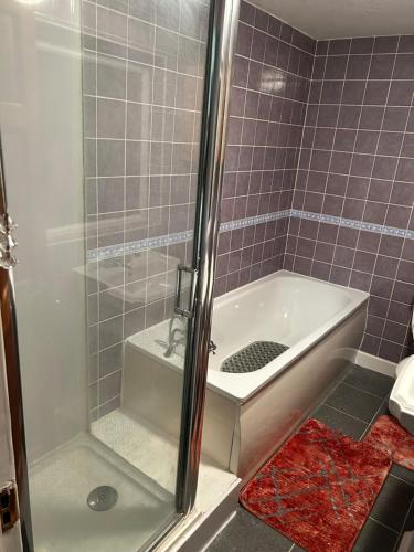 a shower in a bathroom with a sink and a tub at Comfort at its best! in Gillingham