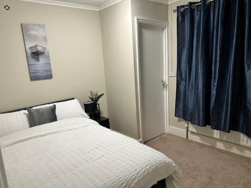 a bedroom with a white bed and a window at Comfort at its best! in Gillingham