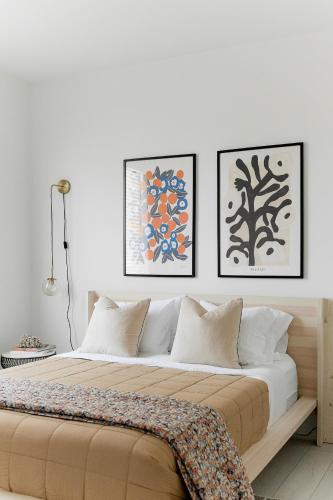 a bedroom with a large bed with three pictures on the wall at Moses Lake Golf Retreat @ Resorts At Moses Pointe in Moses Lake
