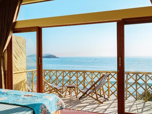 a balcony with a view of the ocean at Life's A Beach in Quy Nhon