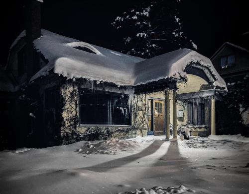 a house with snow on the roof of it at Mistiso's Place Vacation Rentals in Nelson