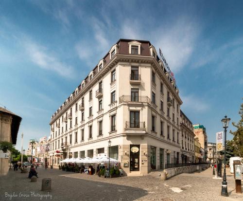 a large white building on a city street at Europa Royale Bucharest in Bucharest