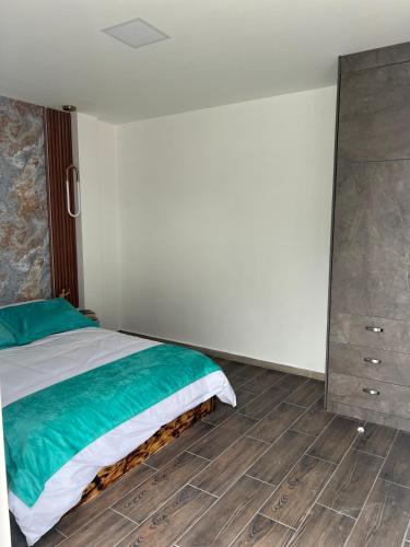 a bedroom with a bed and a dresser at Suit Exclusiva y elegante in Riobamba