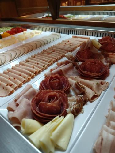 a display case filled with different types of food at Hotel Razgorsek in Velenje