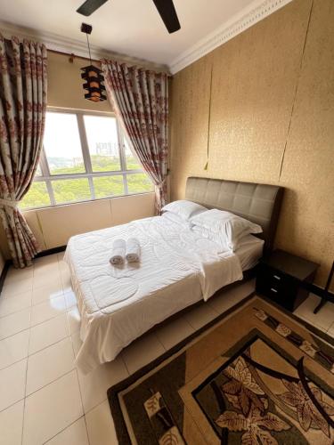 a bedroom with a bed with two glasses on it at Park Avenue, Saujana Damansara in Petaling Jaya