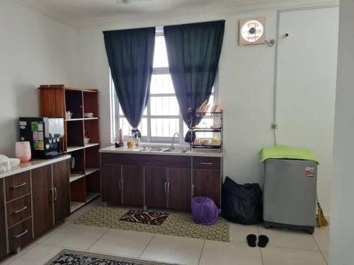 a large kitchen with a sink and a window at Big Homestay For Big Family 2 With Wi fi in Sungai Petani