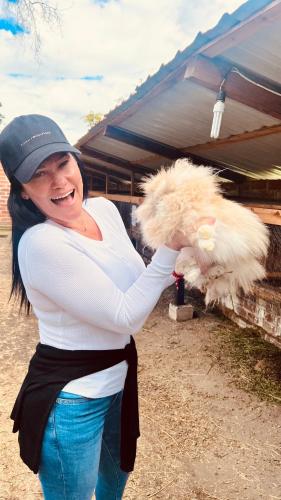 a woman is holding a white stuffed animal at Steingarten, Casa de Campo hermosa y amoblada. in Riobamba