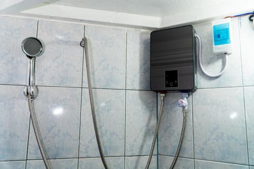 a shower in a bathroom with a phone on the wall at Casa Jessica 329 Dubai style One bedroom Corner unit plus loft in Bacoor