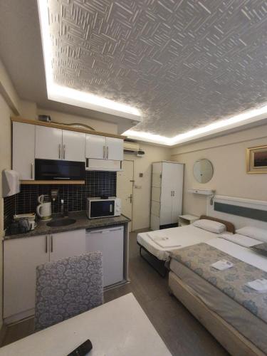 a room with two beds and a kitchen at Lemon Residence in Istanbul