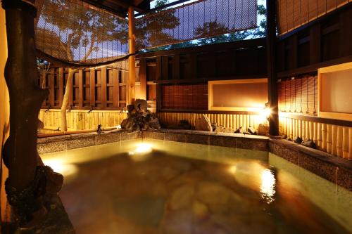 an indoor swimming pool with lights in a building at Taikyourou in Miyazu