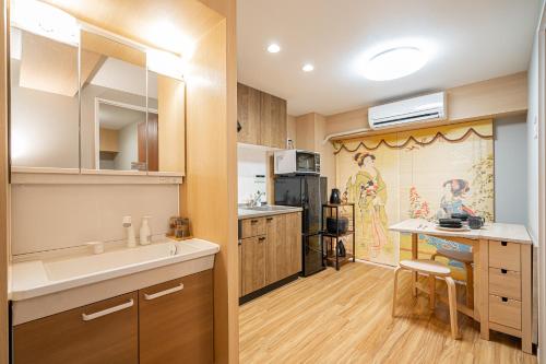 a kitchen with a sink and a counter top at Sakura Suite in Tokyo