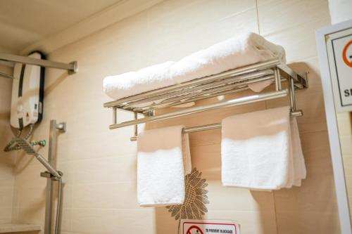 a towel rack in a bathroom with towels on it at ZAN Lodge in Male City